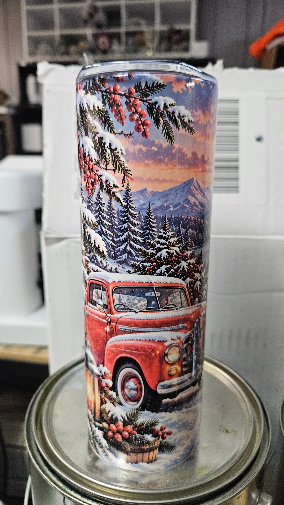 Winter Wonderland 20 oz tumbler with a red vintage truck, snowy evergreens and mountains