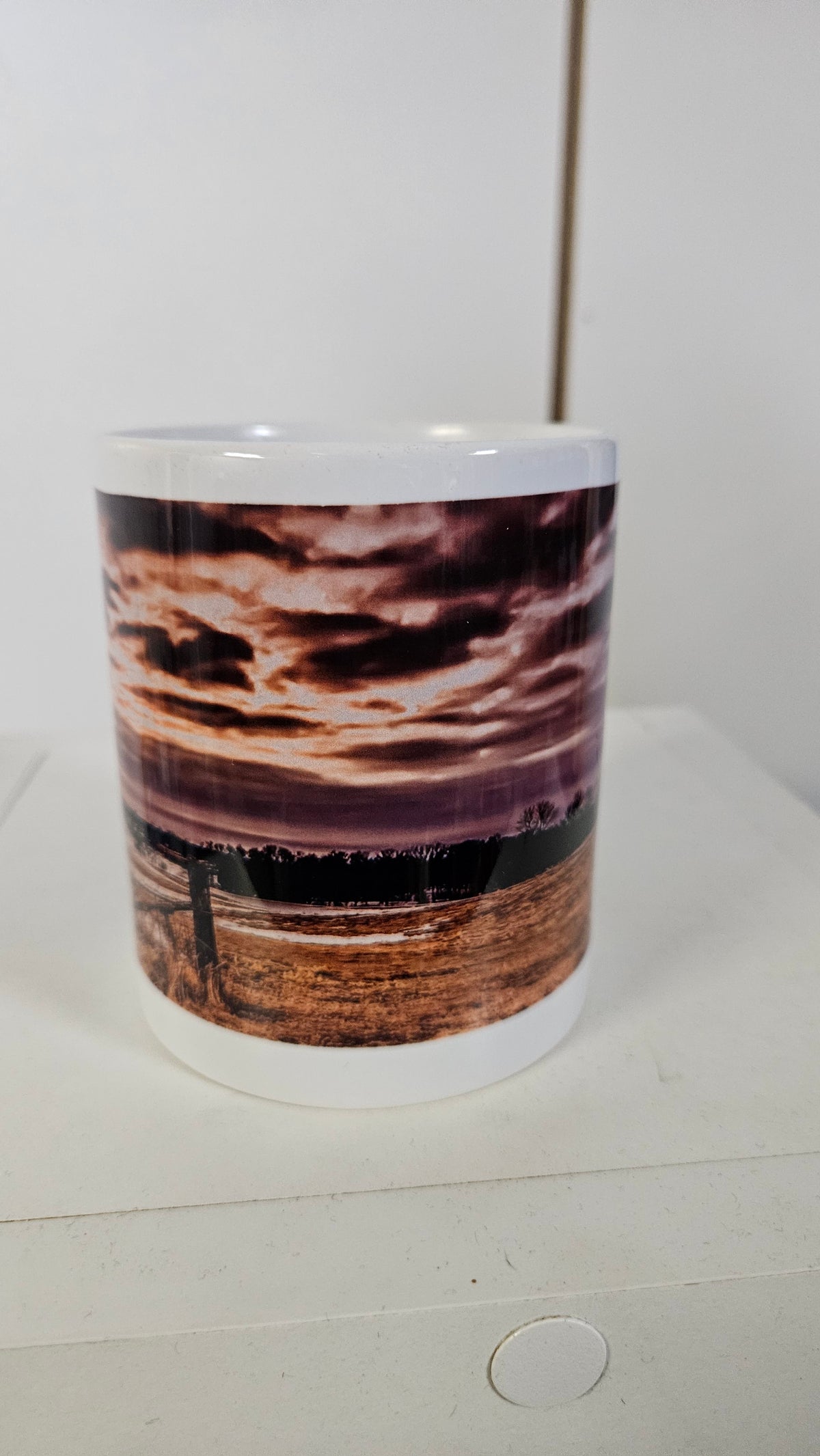 Custom photo mug printed with a dramatic sunset sky over a winter field