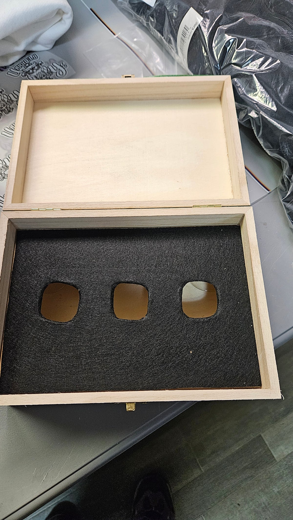 Open wooden keepsake box showing the black felt insert with three golf ball holders